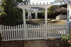 arbor with scalloped picket fence